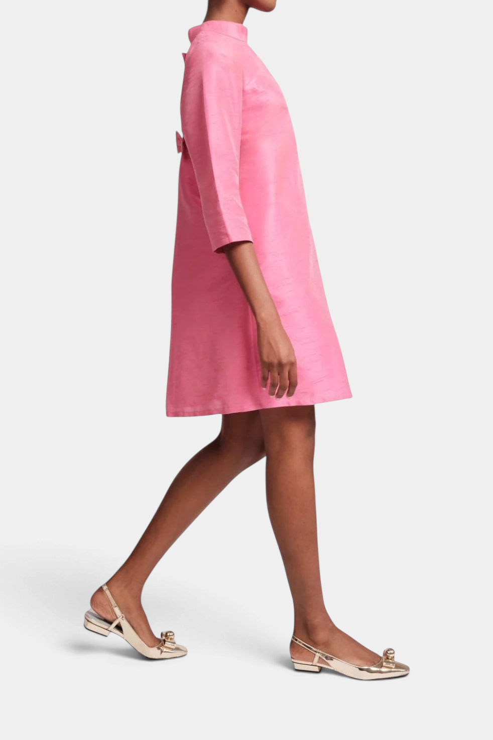 Frances Valentine pink silk A-line dress with high neckline, three-quarter sleeves, and back bow detail on a model.