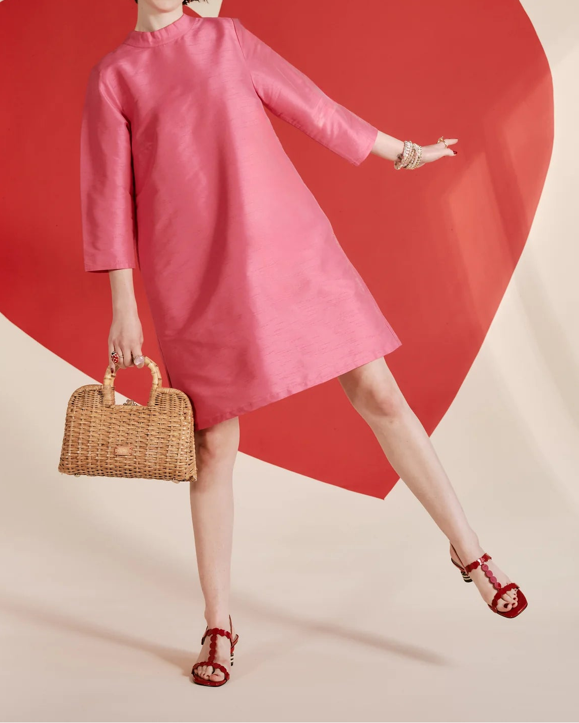 Frances Valentine pink silk A-line dress with high neckline, three-quarter sleeves, and back bow detail on a model.