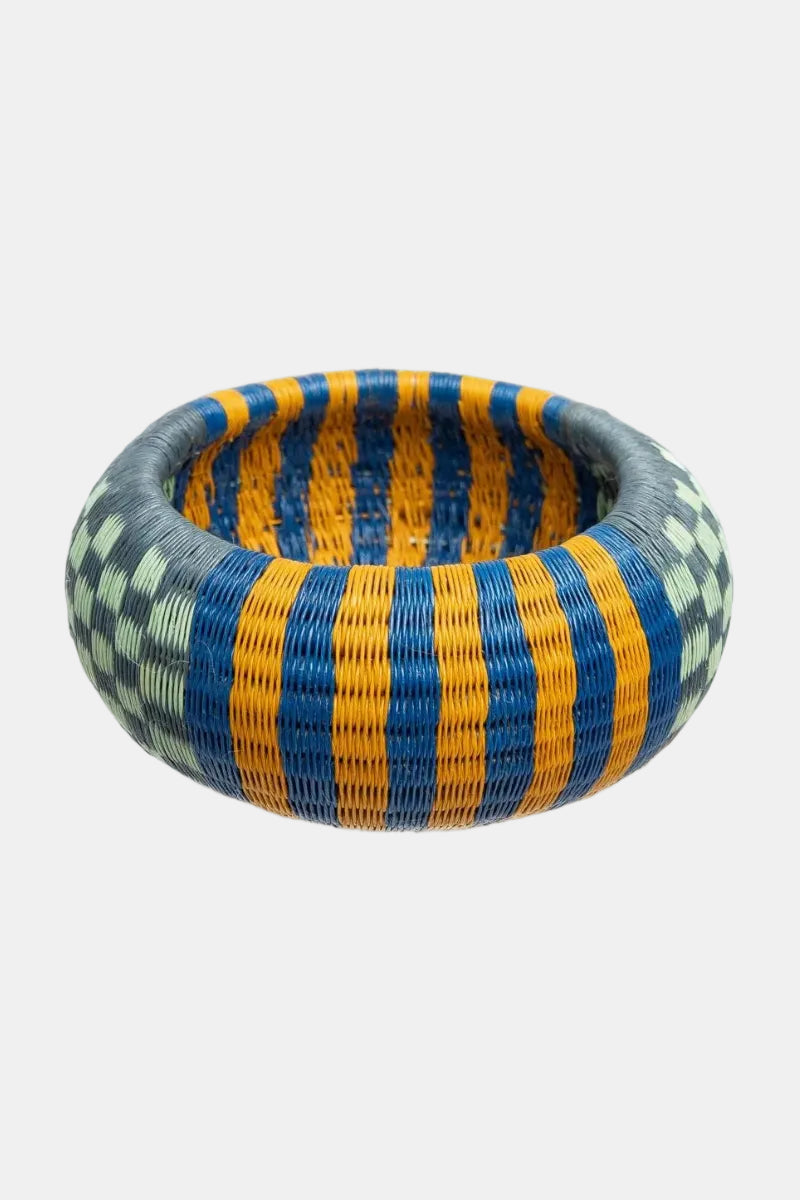 Woven bowl with blue and yellow stripes on a white background