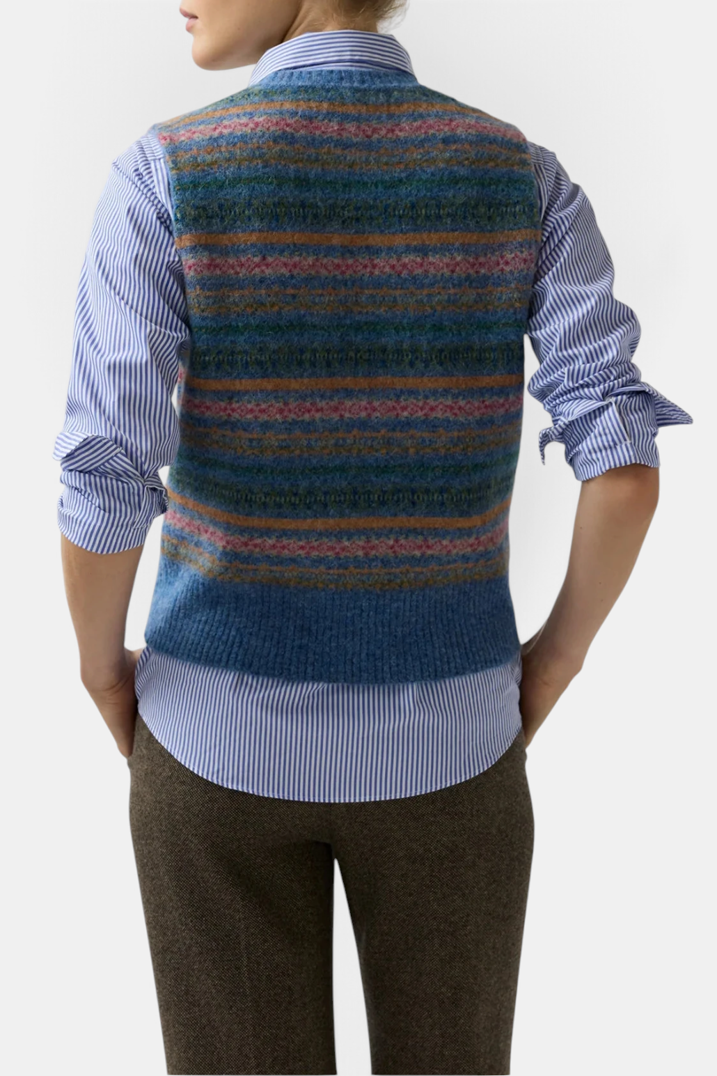 The Copper Shed Silvia fair isle sweater vest in blue brushed alpaca wool blend worn over a striped button-down shirt.
