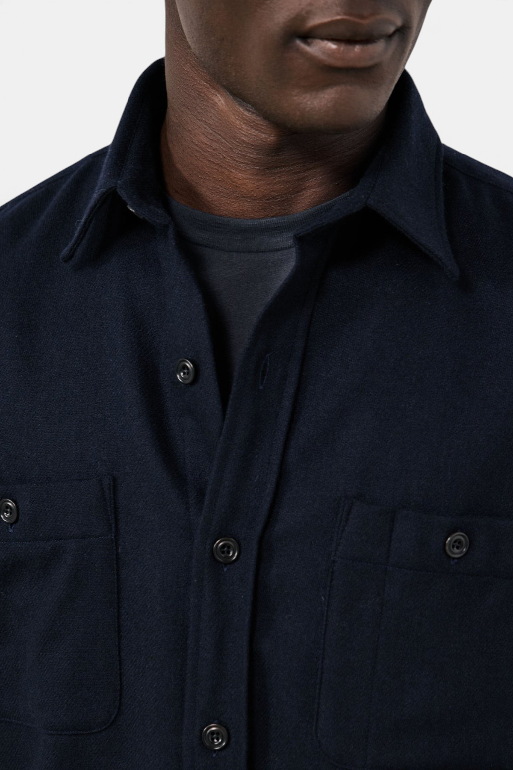 The Copper Shed navy blue boiled wool flannel shirt with a classic collar and buttoned chest pockets.