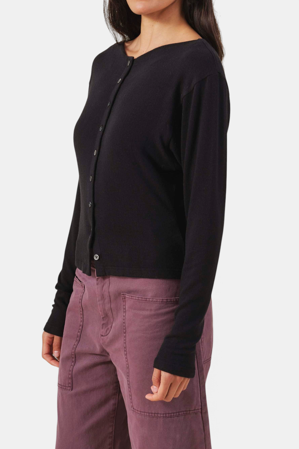 The Copper Shed Jordan black fine-gauge knit cardigan with a round neckline, button front, and thumbhole cuffs.