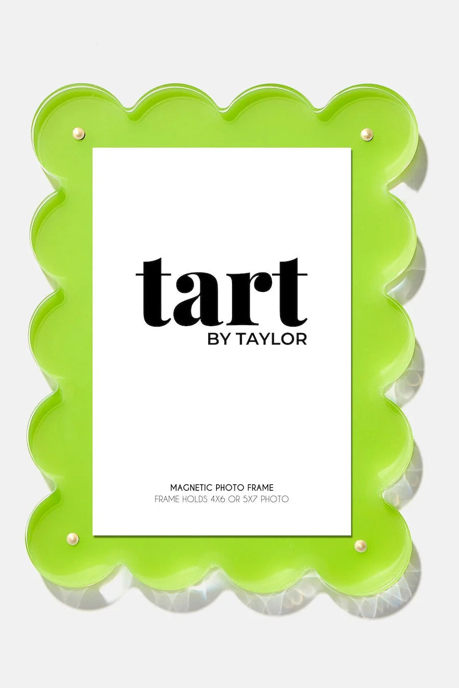 A bright lime green scalloped-edge magnetic photo frame with a white insert card displaying the text 'tart BY TAYLOR' in black, shown on a light gray background.