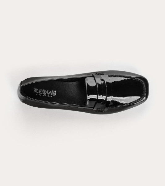 Black patent leather loafer with 'Birkenstock' branding on a white background