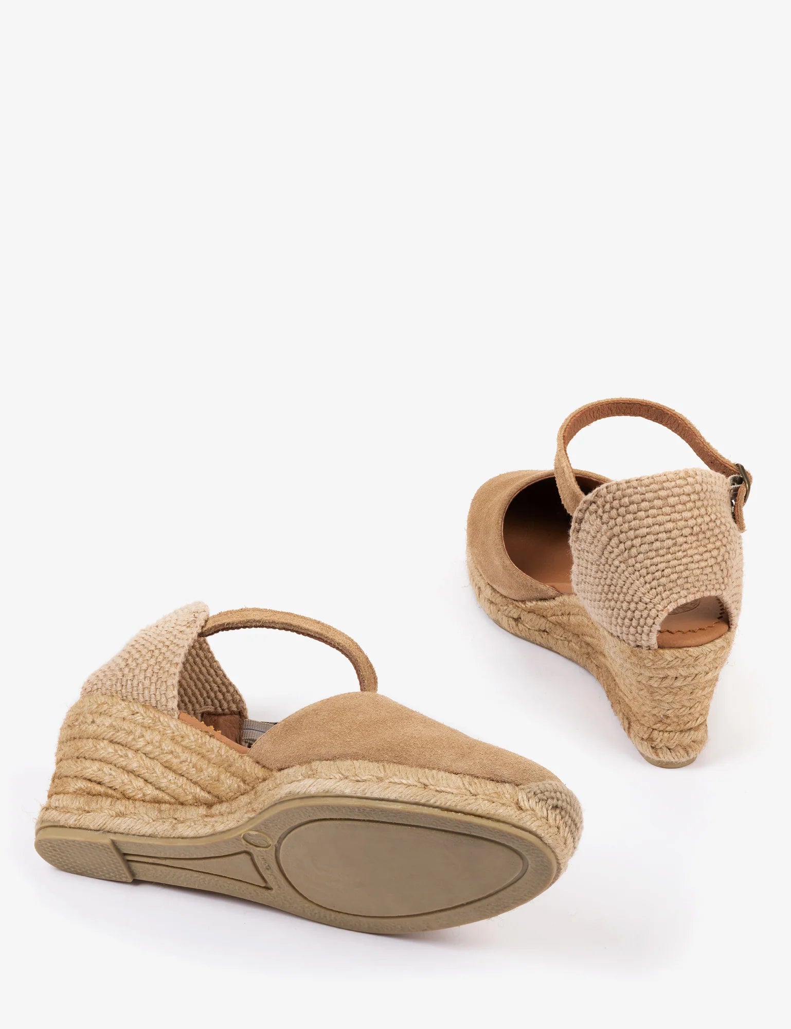 A pair of women's wedge espadrille sandals in beige suede and woven jute, shown from the side and back angles against a plain white background.