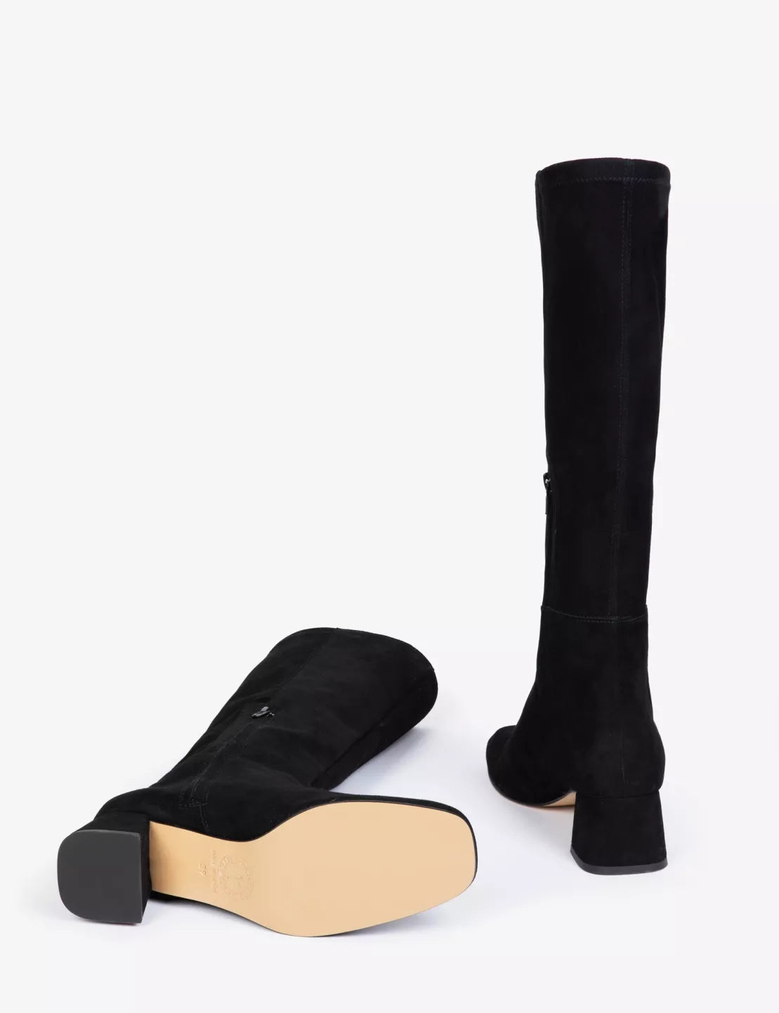 Black knee-high boots with a wooden sole on a white background