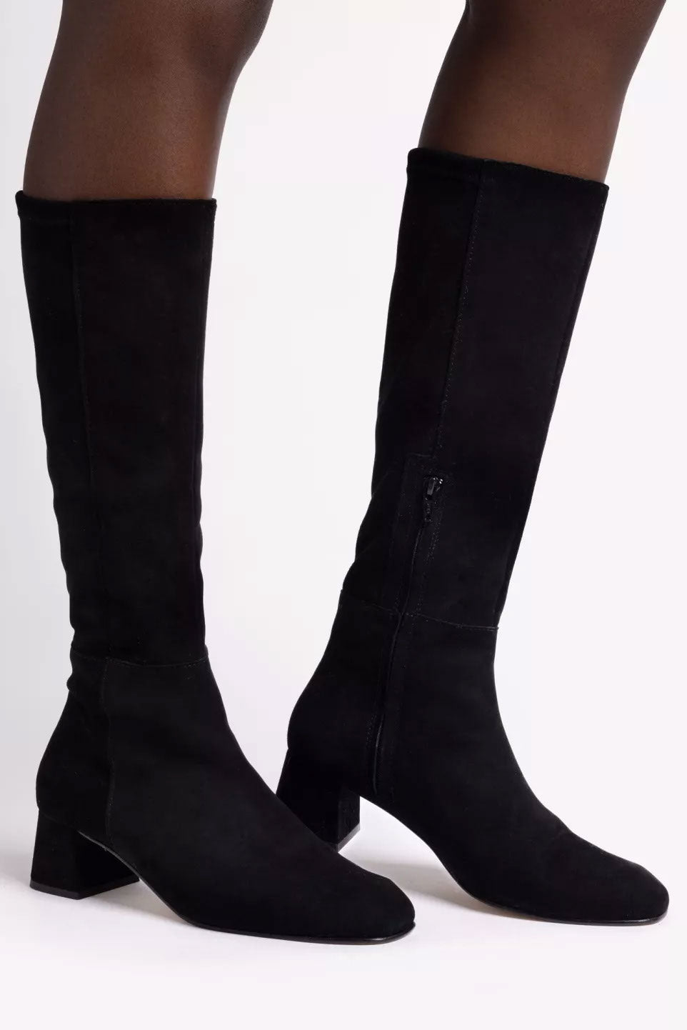 Black knee-high boots on a white background