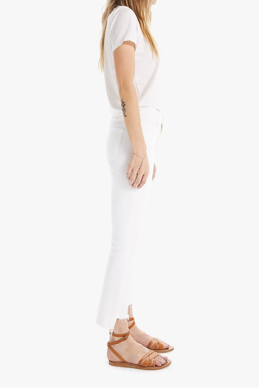 Woman wearing a white dress with a plain background