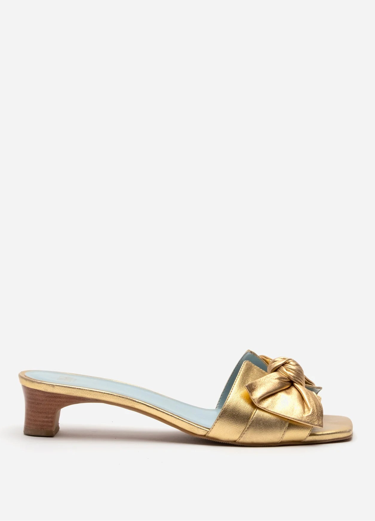 Gold sandal with a bow on a white background