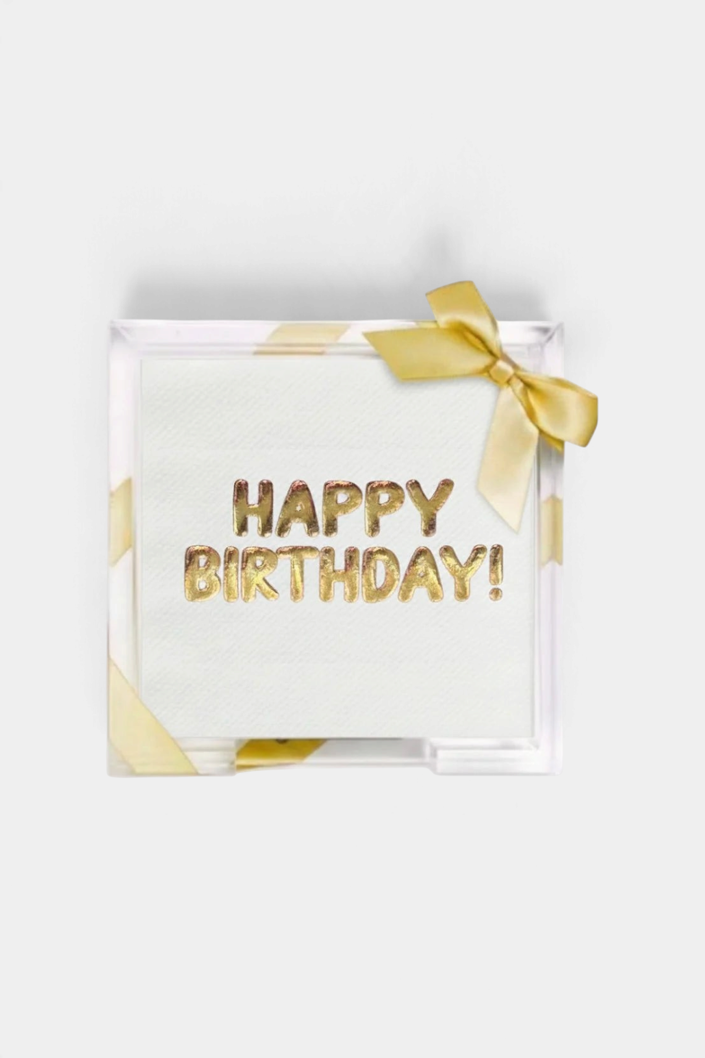 The Copper Shed acrylic tray holding Happy Birthday guest towels with gold foil embossing and a decorative ribbon.