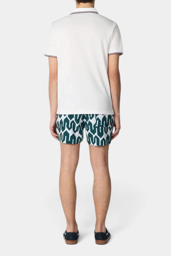 The Copper Shed Ademir men's swim shorts featuring a green geometric print, elastic waist, and orange beak detail.