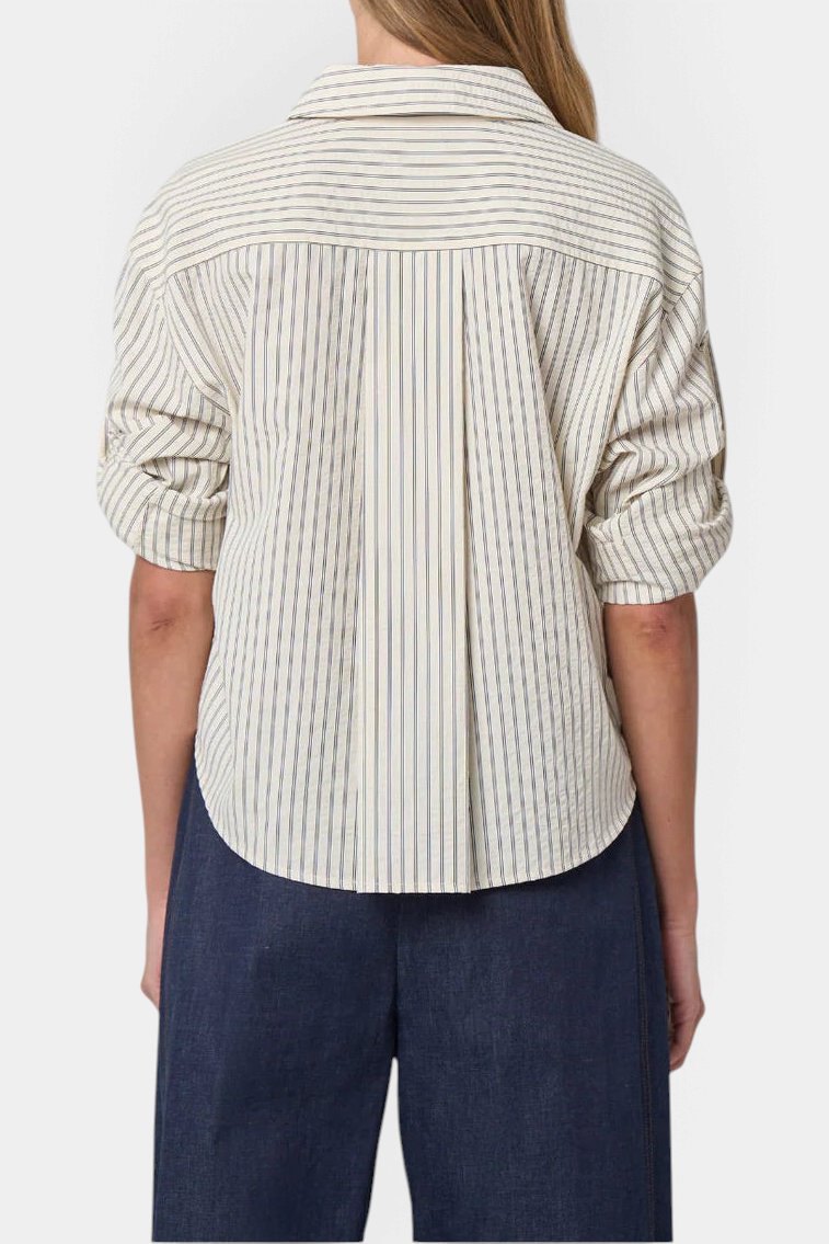 Back view of The Copper Shed Alex striped seersucker shirt with roll-tab sleeves and box pleat detail.