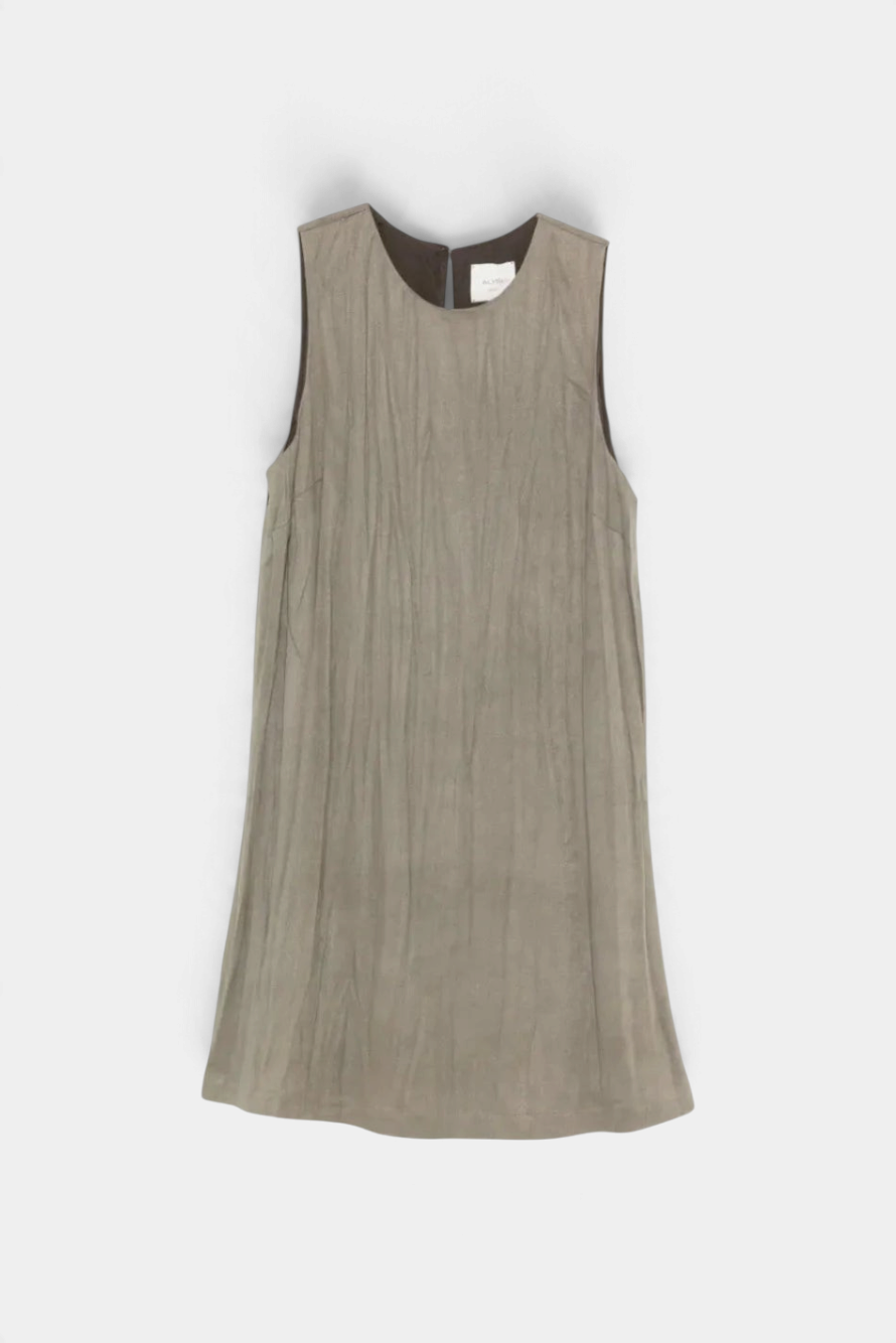 The Copper Shed Alysi sleeveless mini dress in grey with a crinkled texture, scoop neck, and back button closure.