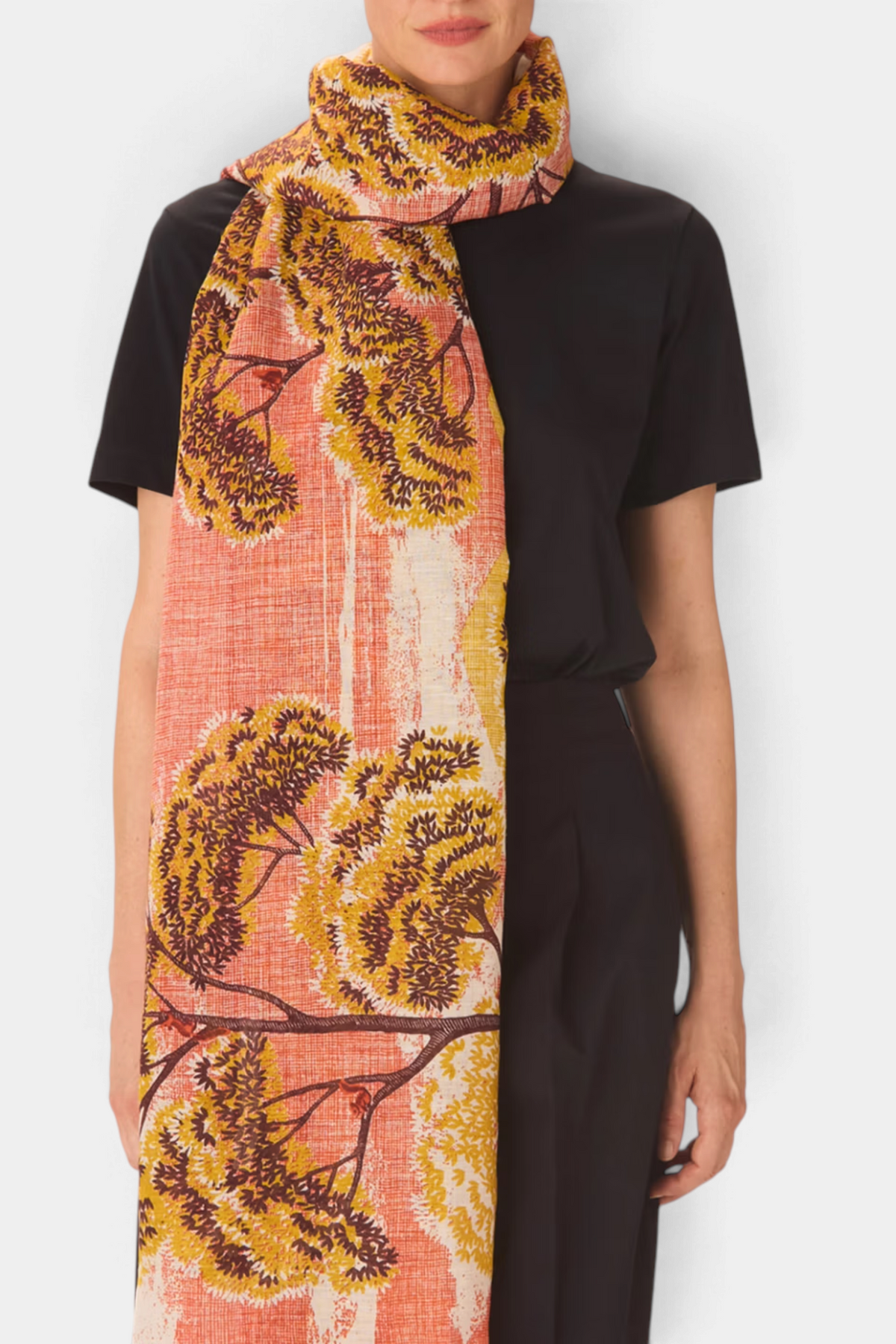 The Copper Shed Ambroise linen-cotton scarf featuring a vibrant orange and yellow hand-printed tree pattern