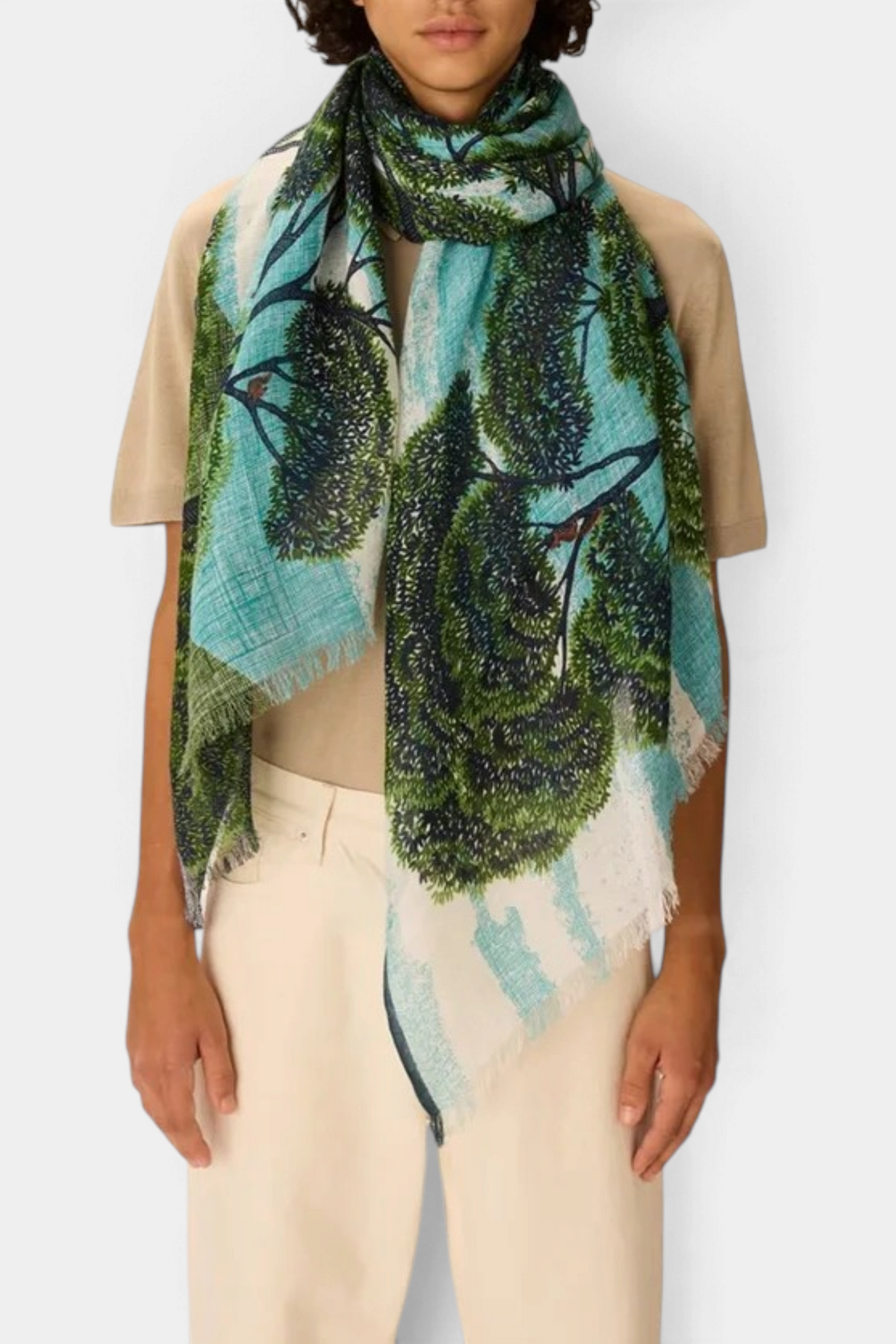 The Copper Shed Ambroise linen and cotton scarf with a green and blue tree print worn by a model