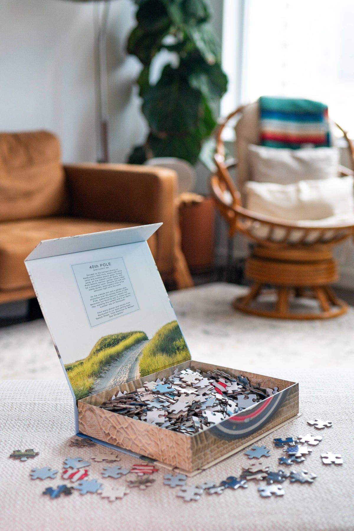 The Copper Shed American Bronco 500 piece puzzle box open on a table with scattered puzzle pieces in a cozy room