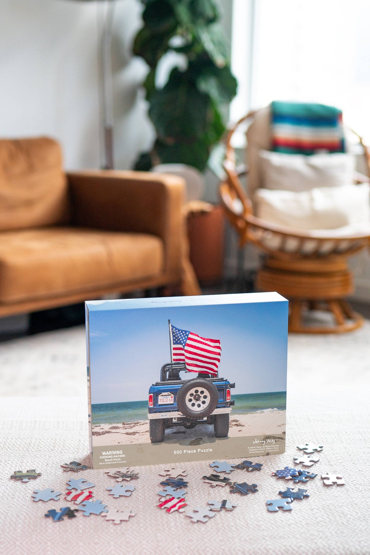 The Copper Shed American Bronco 500 piece puzzle box featuring a blue vintage SUV on a beach with scattered pieces.