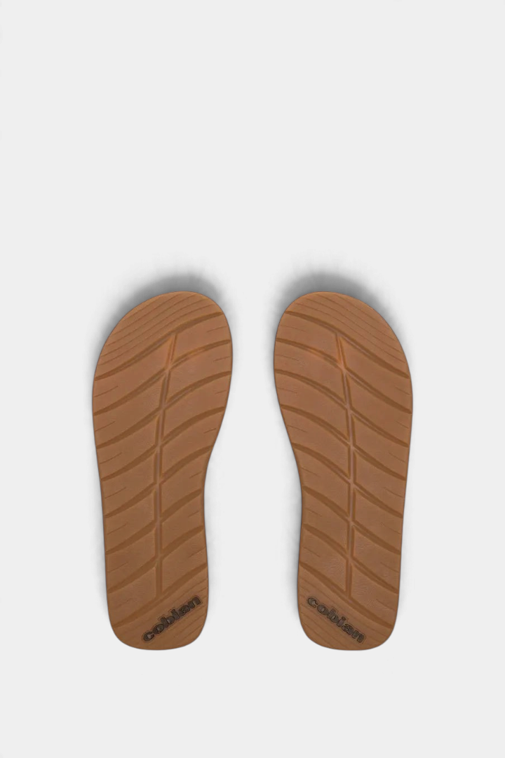 The Copper Shed Anchor flip flop sandals showing the brown rubber outsoles with tread pattern for boat traction