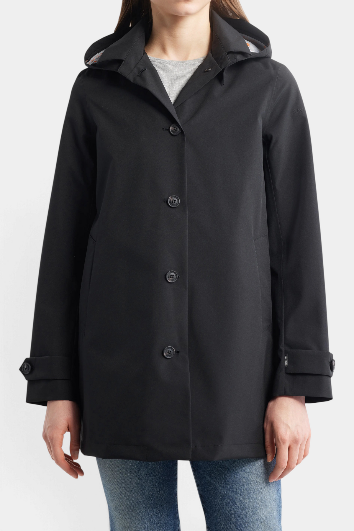 The Copper Shed April hooded black raincoat for women featuring a pointed collar, button front, and side pockets.