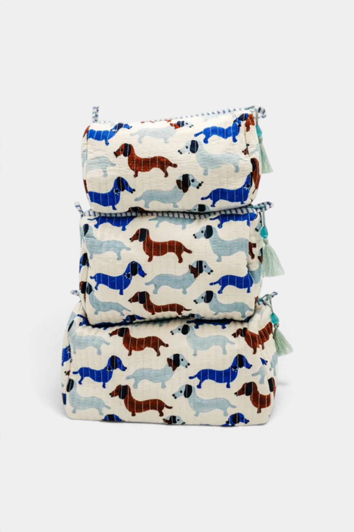The Copper Shed Araminta medium toiletry bag with a cream background and blue and brown dachshund dog print.