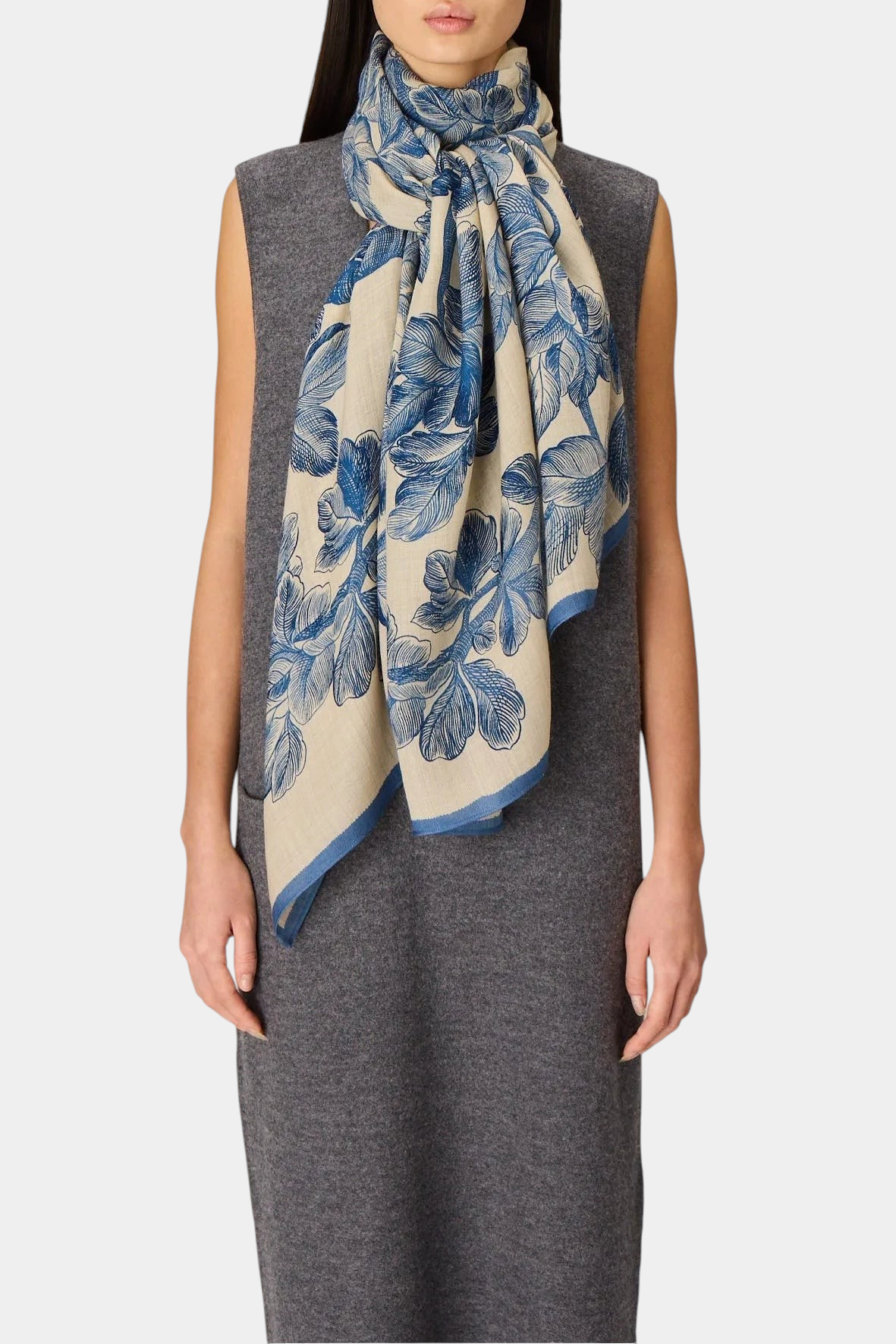 The Copper Shed Arboris blue and cream floral print wool scarf worn by a model in a grey sleeveless dress