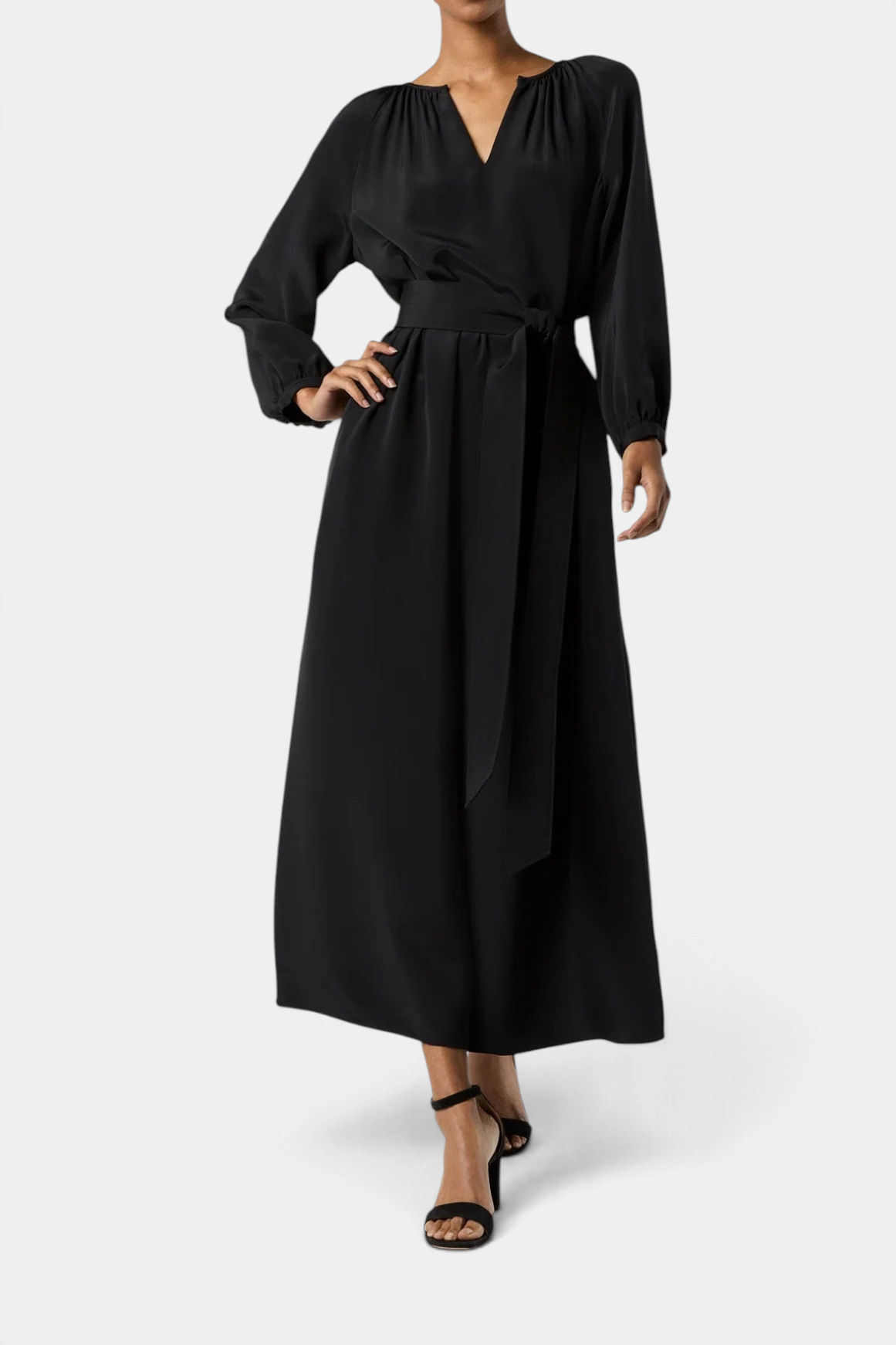 The Copper Shed Ariana black crepe de chine maxi dress with long sleeves and a tie waist belt on a model
