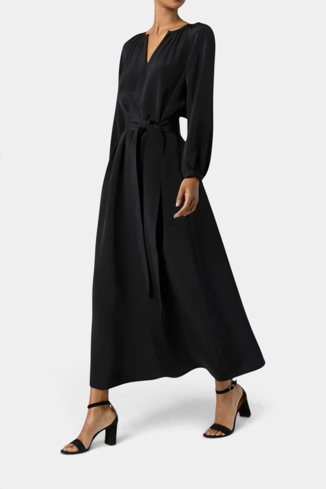 The Copper Shed Ariana maxi dress in black crepe de chine with long sleeves, a tie waist, and hook-and-eye closure.