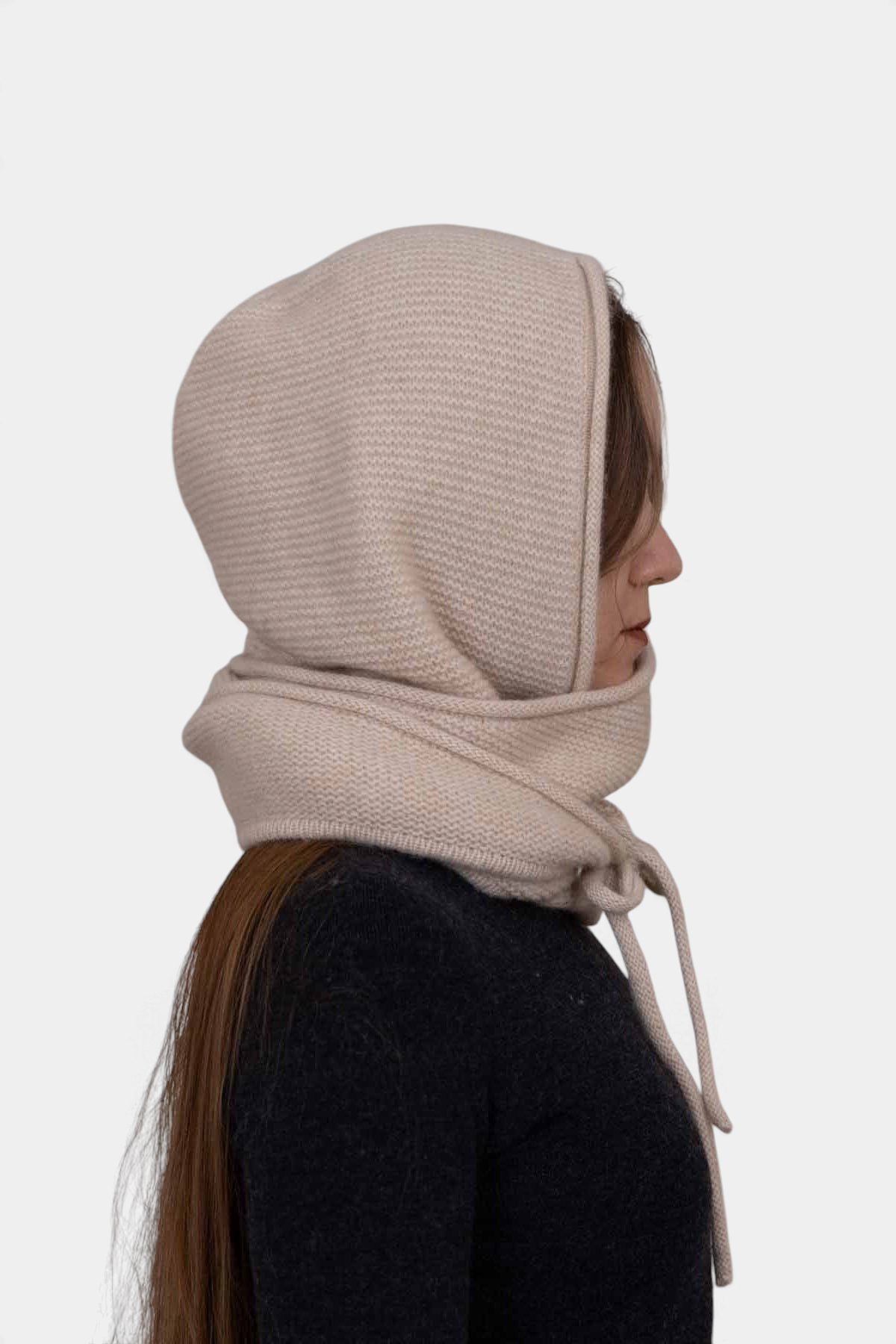 The Copper Shed Eden hooded scarf in beige organic cashmere worn by a woman, side profile view.