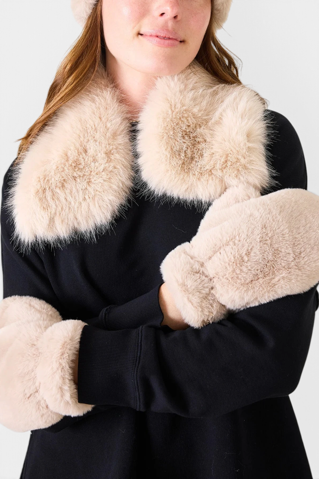 The Copper Shed beige faux fur collar worn over a black sweater with matching mittens and hat.