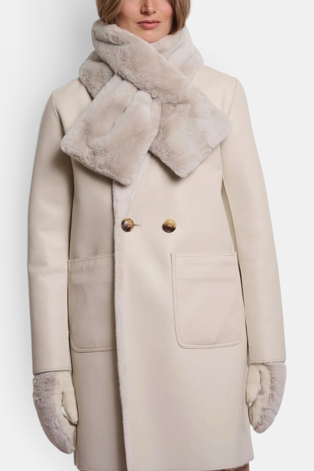 The Copper Shed beige faux fur scarf worn over a matching coat with a crossed open detail.