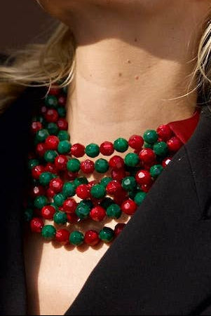 The Copper Shed Bella novelty necklace featuring layered red and green resin beads on a leather collar.