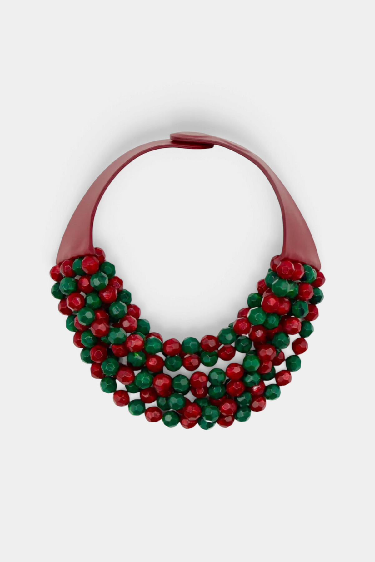 The Copper Shed Bella novelty necklace featuring layered red and green resin beads on a maroon leather collar.