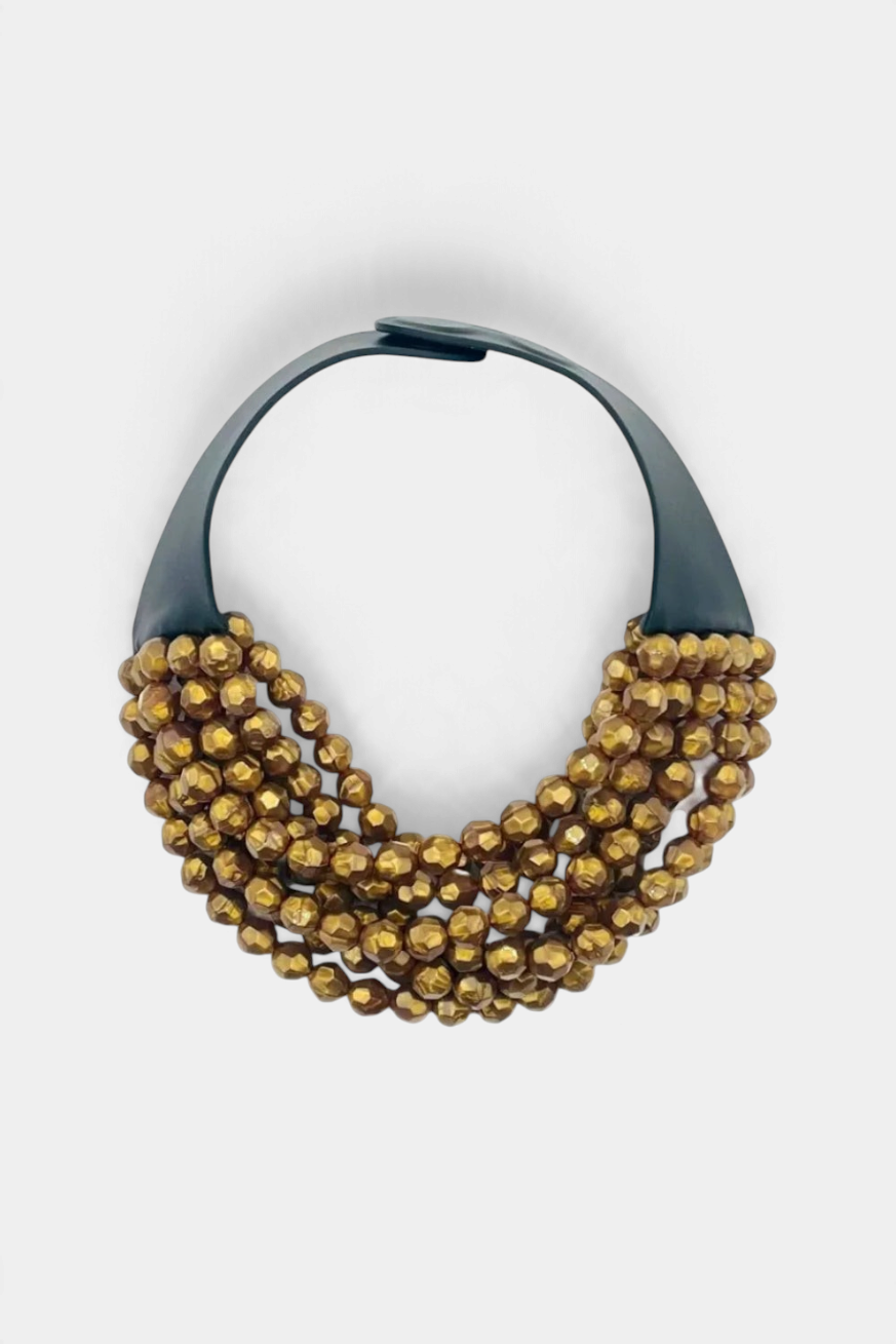 The Copper Shed Bella Holiday gold resin bead necklace with a layered design on a black leather collar.