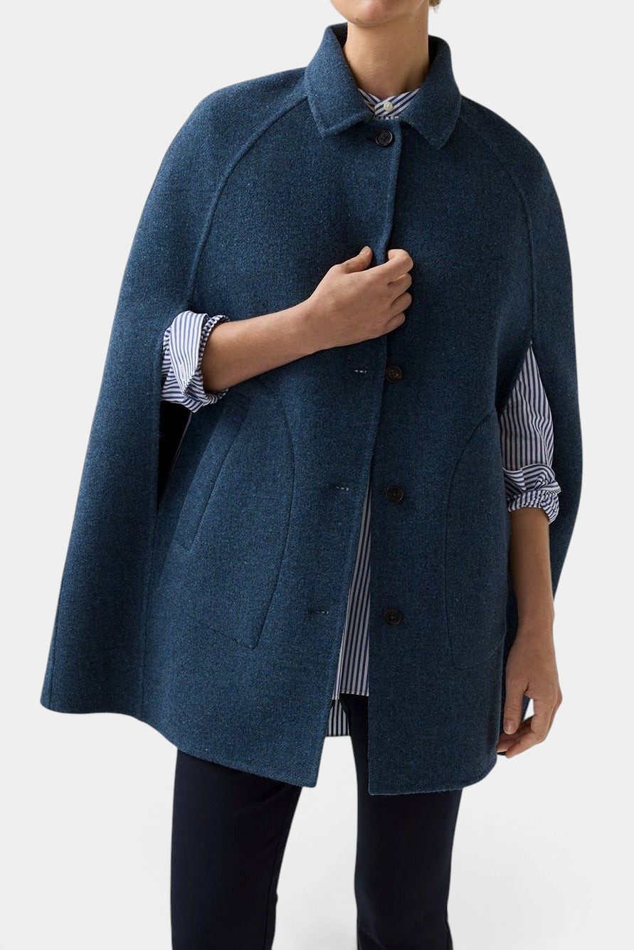 The Copper Shed Bennet tailored cape in blue Harris Tweed wool with a button-front closure and felt undercollar.