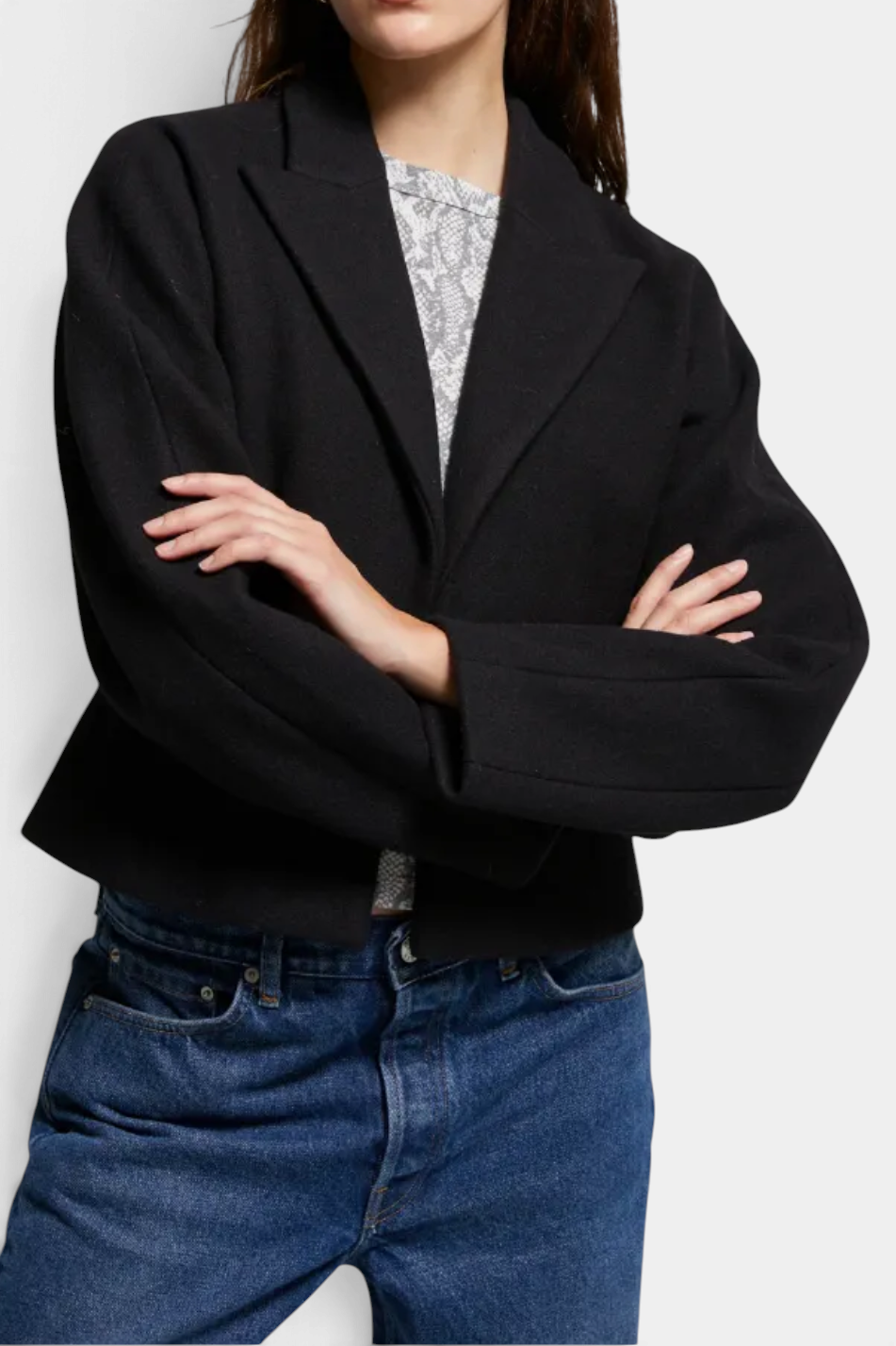 The Copper Shed Bethany blazer in black brushed felt with a cinched waist and sharp lapels worn over denim jeans.