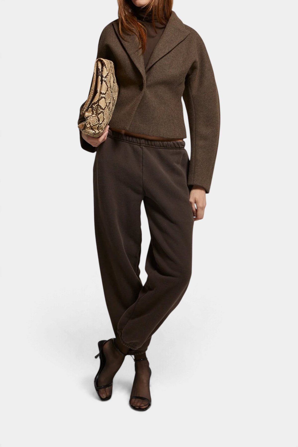 The Copper Shed Bethany Blazer in brown brushed felt with a cinched waist, styled with dark sweatpants and heels.