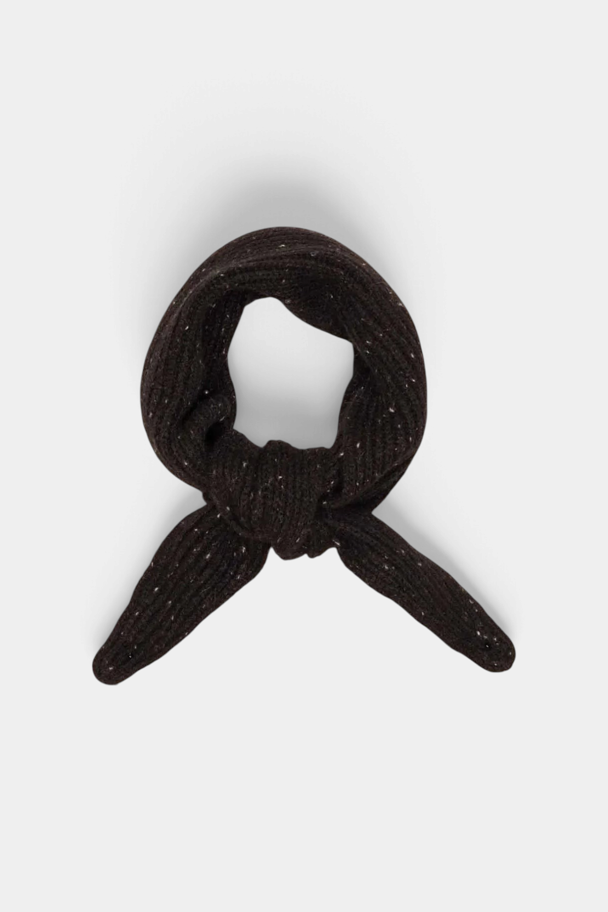 The Copper Shed black organic cashmere neck scarf with subtle colourful speckles, tied in a compact knot.