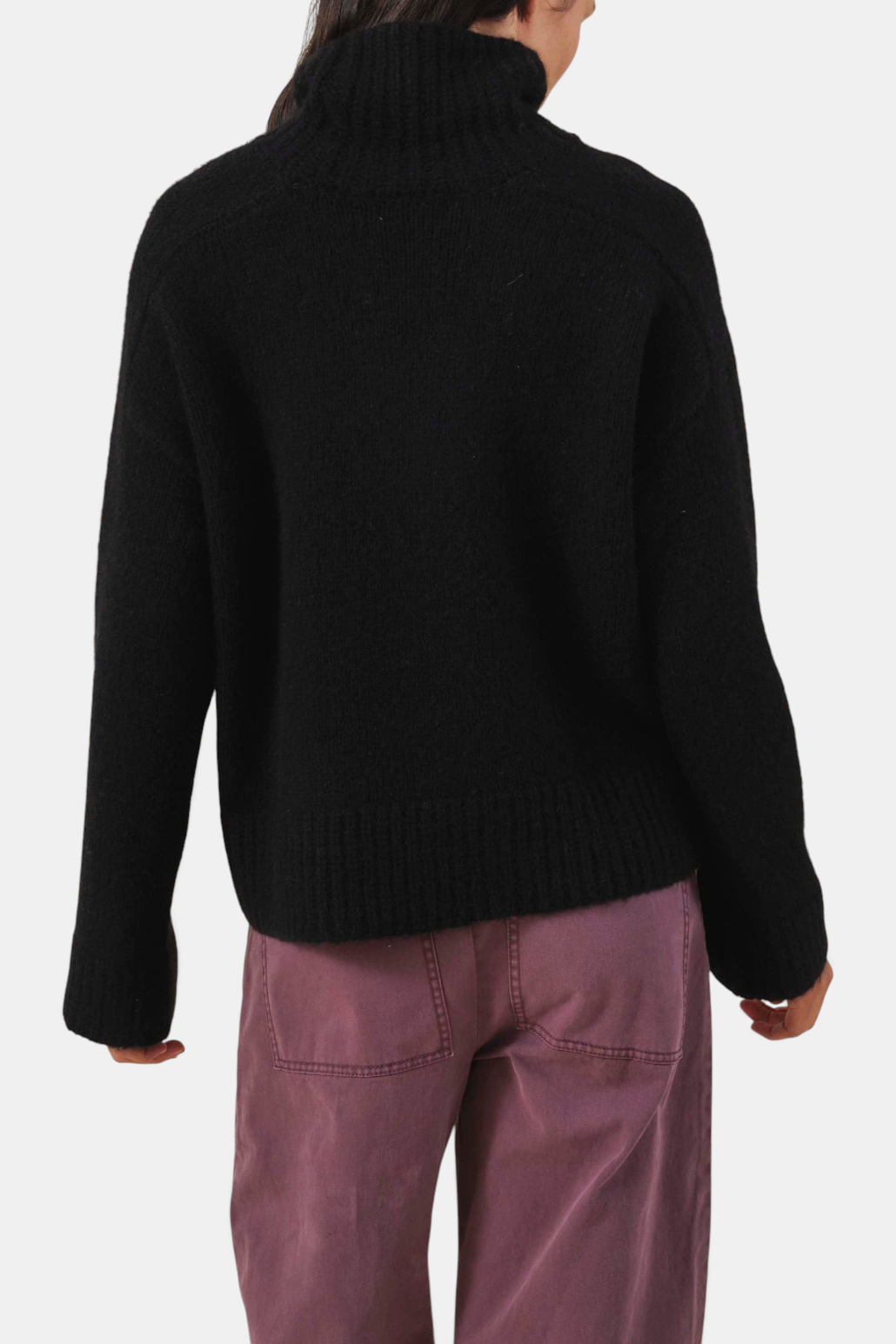 The Copper Shed black cashmere blend turtleneck sweater with ribbed trim, shown from the back.