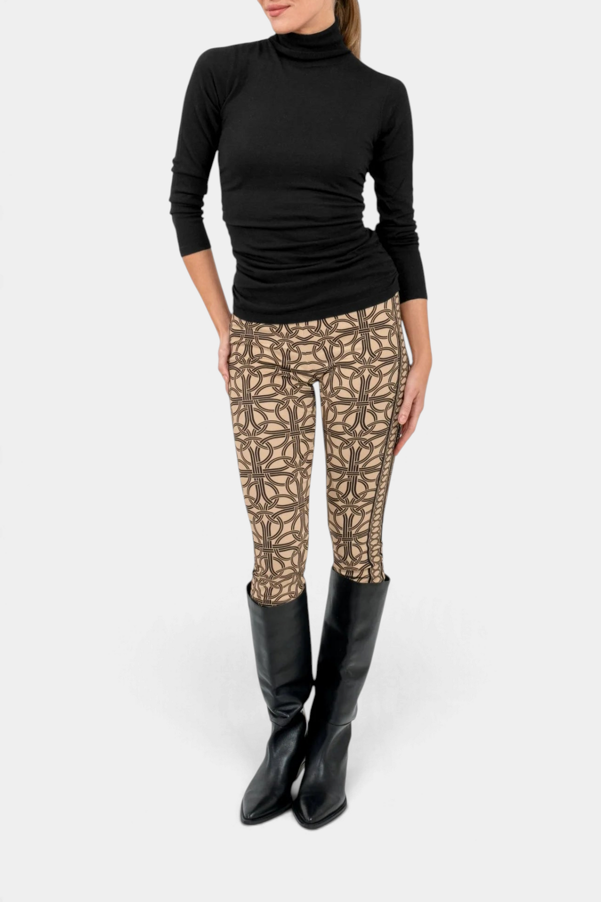 The Copper Shed I'm Too Sexy black cashmere turtleneck sweater paired with patterned leggings and black boots