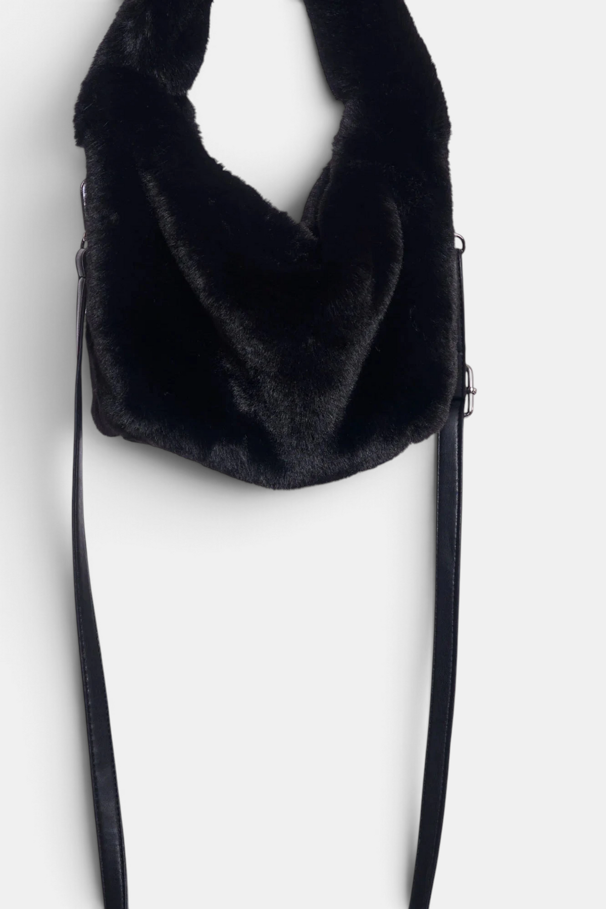 The Copper Shed black faux fur crossbody bag with a removable shoulder strap and secure zipper closure.
