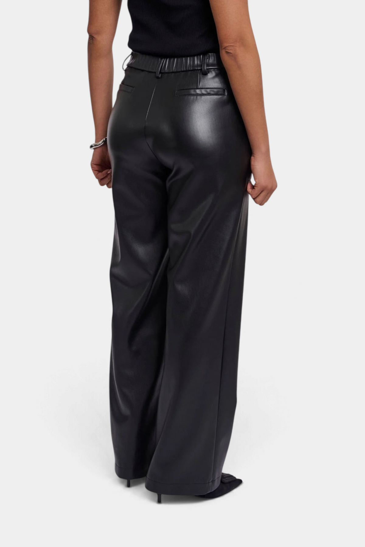 The Copper Shed Georgina straight-leg trousers in black faux leather with an elasticated waistband, back view.