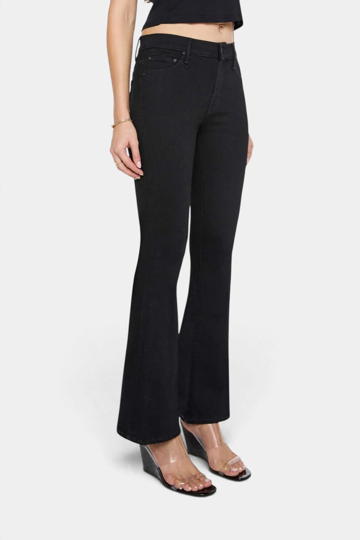 The Copper Shed The Weekender mid-rise black flare jeans with a clean hem worn by a model
