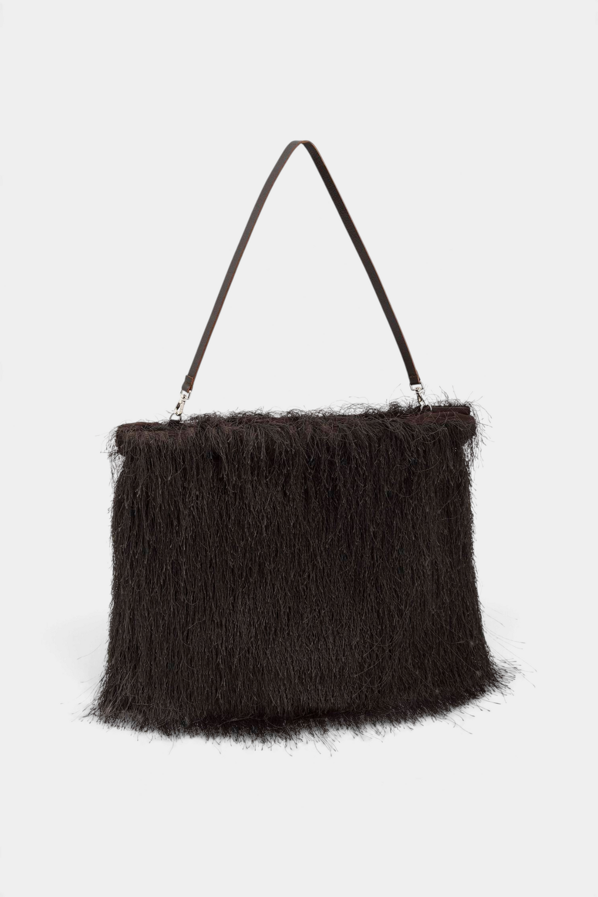 The Copper Shed black maxi shoulder bag with long fringes, removable brown leather handle, and silver snap hooks.