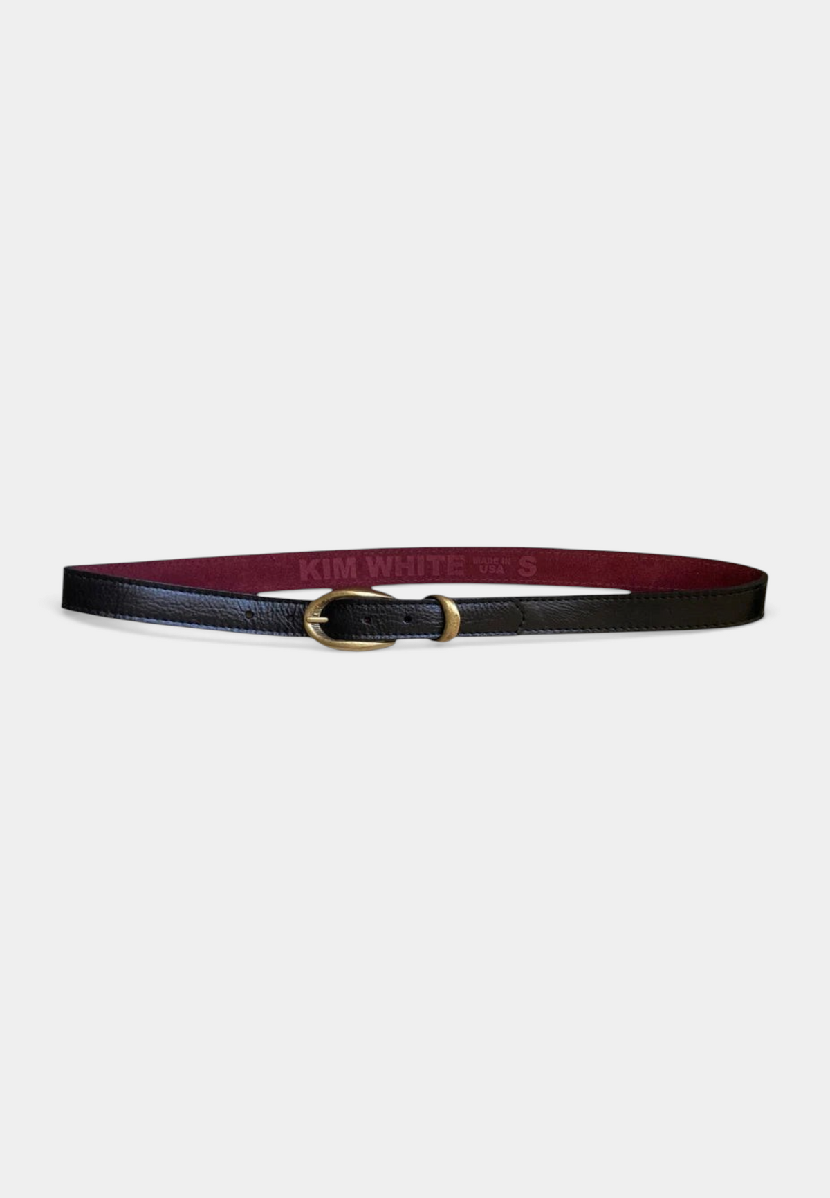 The Copper Shed black pebbled leather belt with an etched antique brass buckle and burgundy suede lining.
