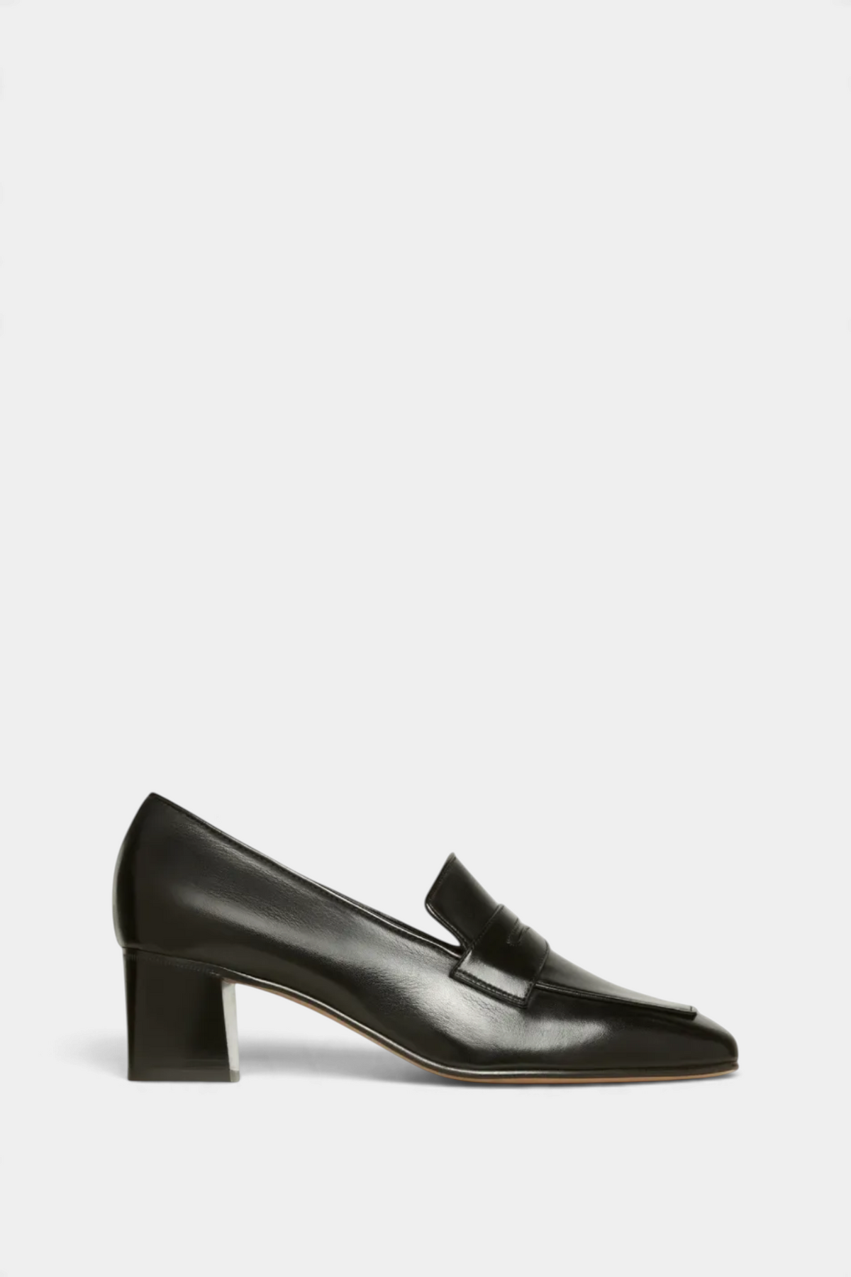 The Copper Shed black leather heeled loafer with a traditional penny slot and block heel, side profile view.