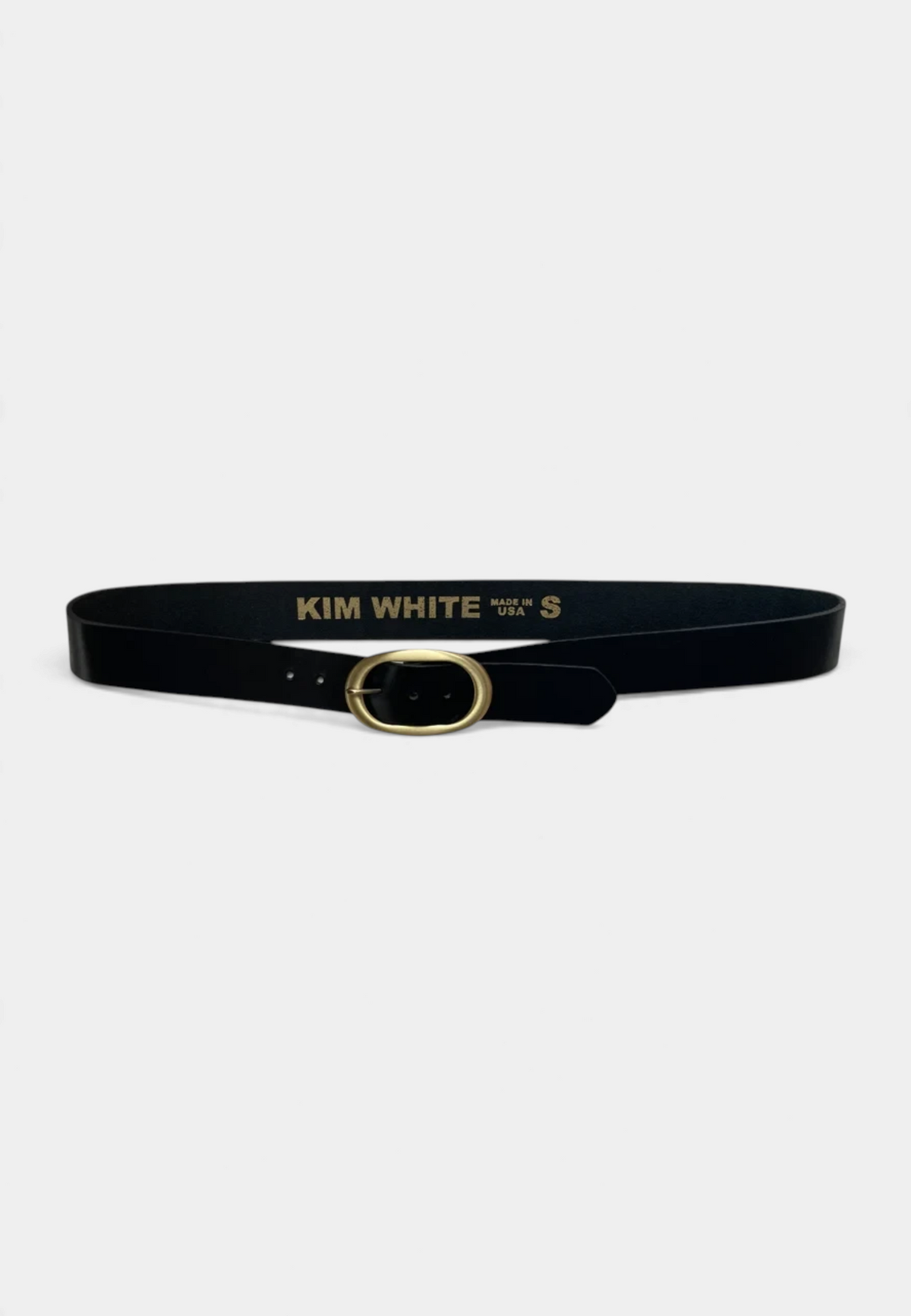 The Copper Shed black leather belt featuring an antique elongated oval brass buckle and a clean, classic design.