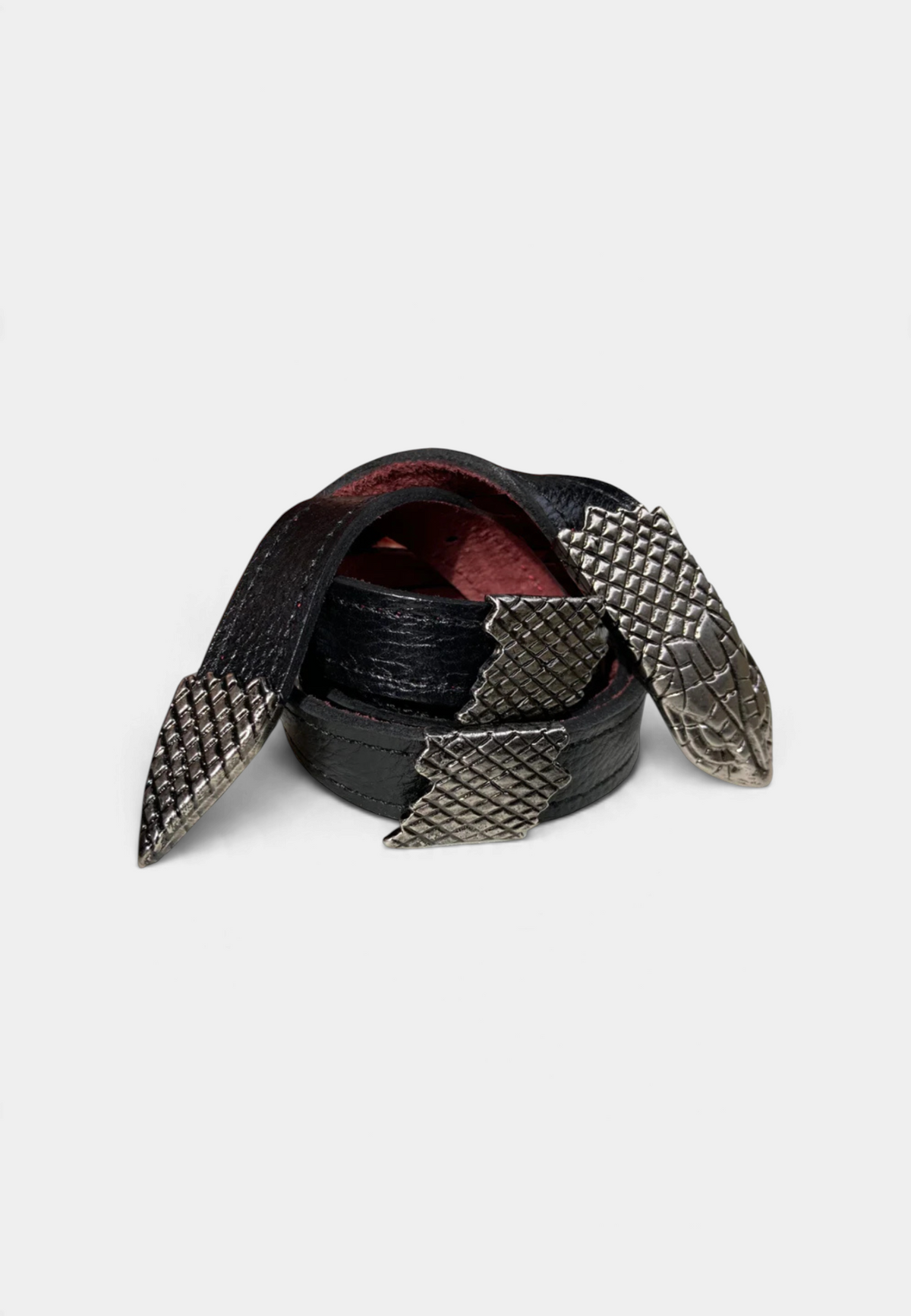 The Copper Shed black leather skinny belt featuring four antique nickel snake castings with detailed scale textures.