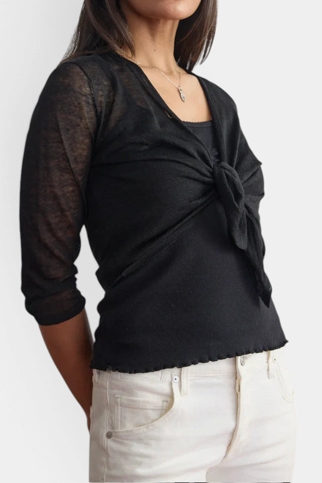 The Copper Shed black linen ballet wrap with long sleeves and a tie-front detail worn over a matching camisole.