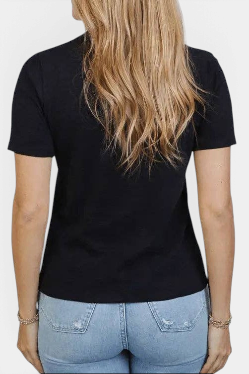 Back view of The Copper Shed black Pima cotton short sleeve tee with gathered shoulder detail on a woman