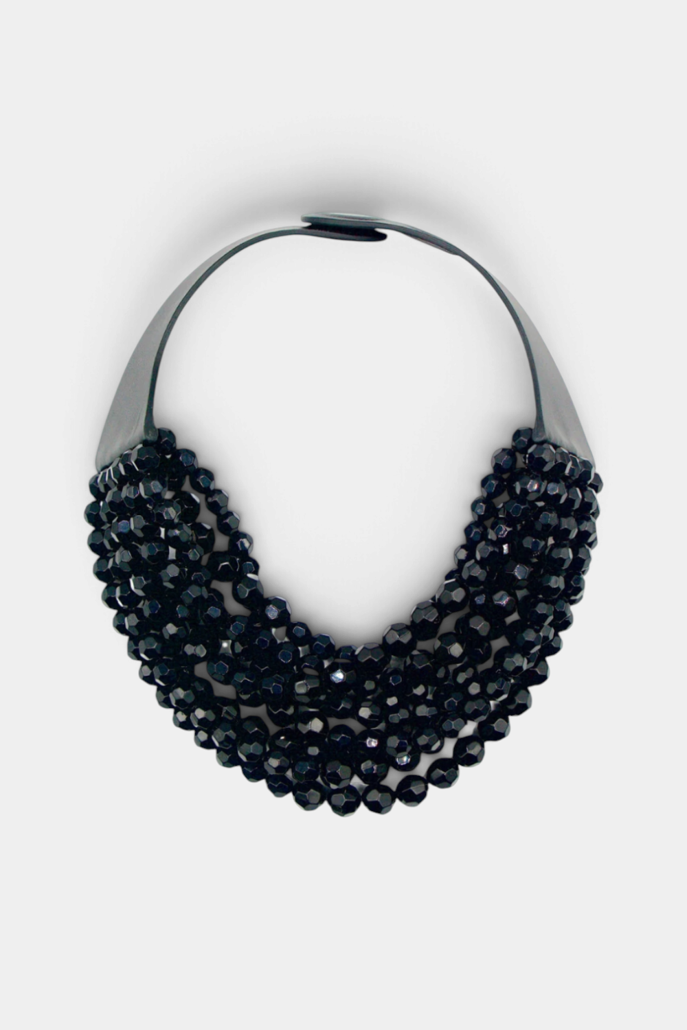 The Copper Shed Bella Grace multi-strand necklace featuring faceted black resin beads in a waterfall silhouette.